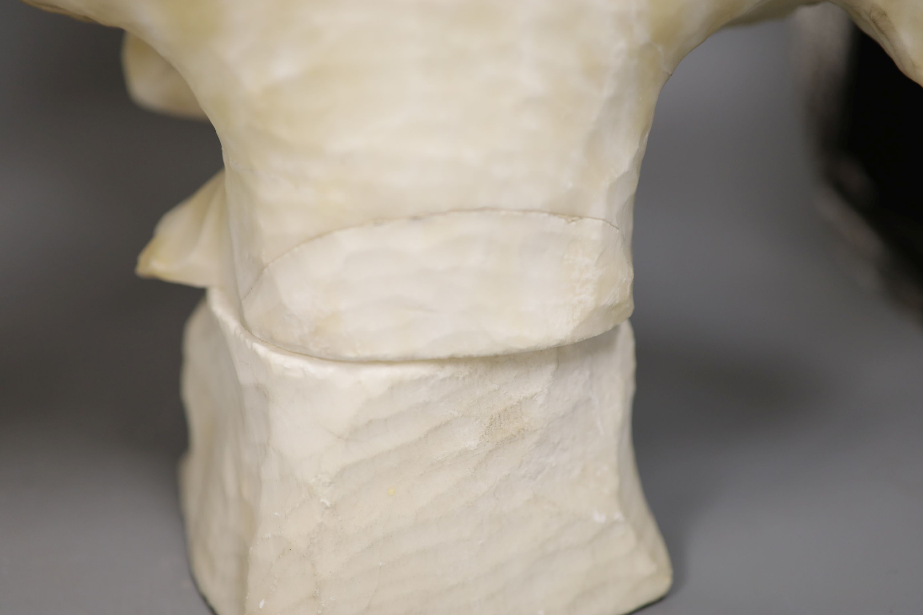 Two white alabaster busts of young women, raised on turned plinths 44cm